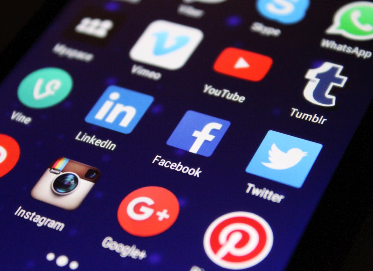 The Art of Drawing Readers In: Your attractive post title goes here Close-up of a smartphone screen showing various social media app icons such as Facebook and Twitter.